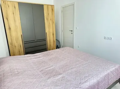 a bedroom with a bed with a pink comforter at Saltwater Escape in Sozopol in Sozopol