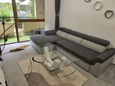 a living room with a couch and a glass table at Cascadas pool view luxury apartment Sunny beach in Sunny Beach