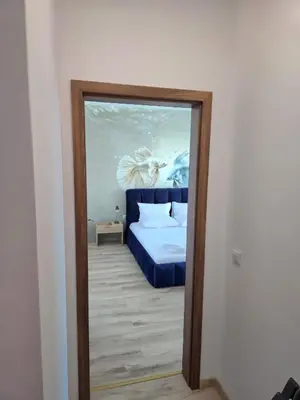 a mirror in a room with a bed at Апартамент 