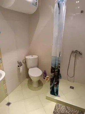 a bathroom with a toilet and a shower curtain at MIDIA Family Resort - studio s výhledem na moře in Aheloy