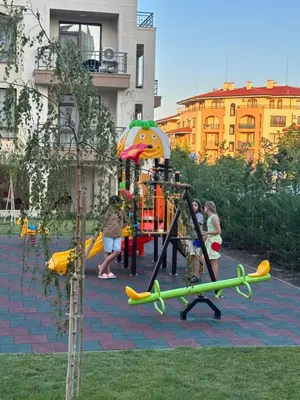 a playground with children playing on a play equipment at Sveti vlas apartament Sorrento Sole Mare V&D Luxury Style Apartment Свети-влас апартамент студио in Sveti Vlas
