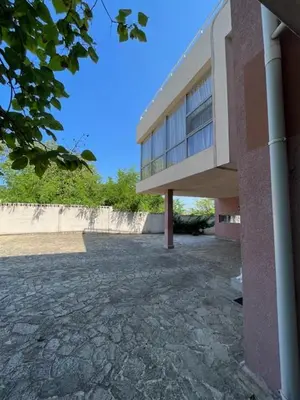 a building with a stone walkway in front of it at Sunny house in Pismenovo