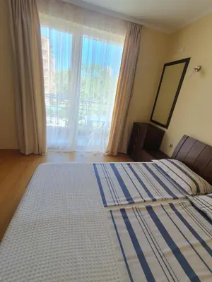 a bedroom with a bed and a large window at Sea Apartament Kristal Beach,Nessebar in Nesebar