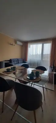 a living room with a large table and chairs at Sea Apartament Kristal Beach,Nessebar in Nesebar