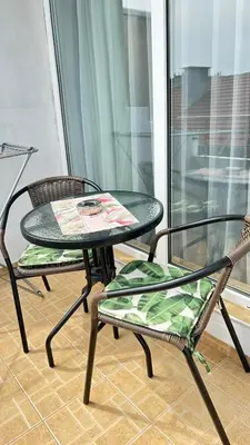 two chairs and a table and two chairs on a balcony at Guest House Dani in Pomorie