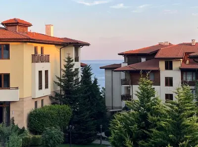 a group of houses with trees and the ocean at Apartament Studio Bułgaria Garden Of Eden in Sveti Vlas