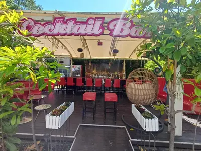 a restaurant with red chairs and a sign that reads cocktail box at Admiral Plaza 35 -studio-Sunny Beach in Sunny Beach