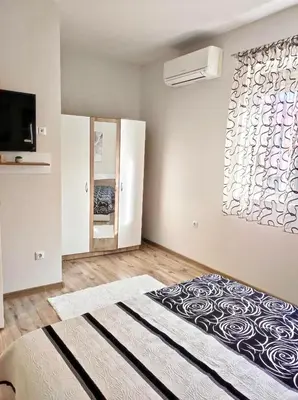 a bedroom with a large bed and a window at VN Home 2 in Pomorie