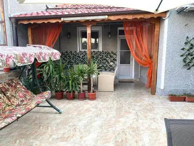 a patio with an umbrella and plants on a house at VN Home 2 in Pomorie