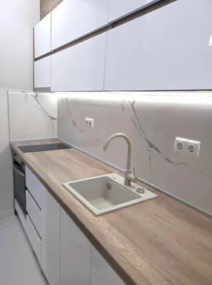 a white kitchen with a sink and a counter at VN Home 2 in Pomorie