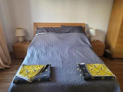 a bedroom with a bed with two pillows on it at Vineyard luxery spa resort in Kableshkovo