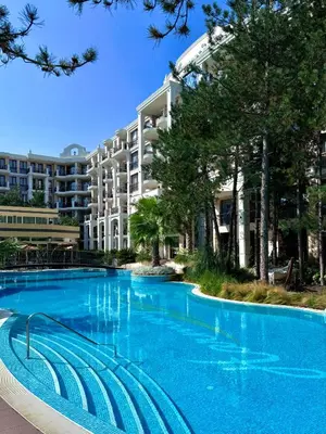 a large swimming pool in front of a building at Harmony Grand Resort - Apartament Gut in Sunny Beach