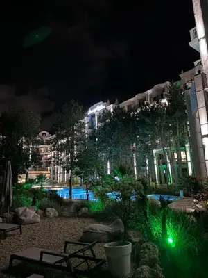 a night view of a building with a swimming pool at Harmony Grand Resort - Apartament Gut in Sunny Beach