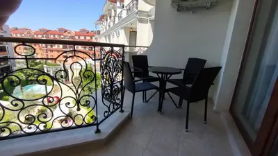 a balcony with a table and chairs on a balcony at Luxuriöse Ferienwohnung im Harmony Suites Monte Carlo in Sunny Beach