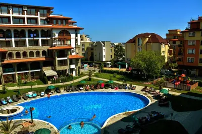 a large swimming pool in a city with buildings at Olymp SkyView Apartment in Sveti Vlas