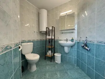 a bathroom with a toilet and a sink at BW - Aquamarin C6 in Sunny Beach