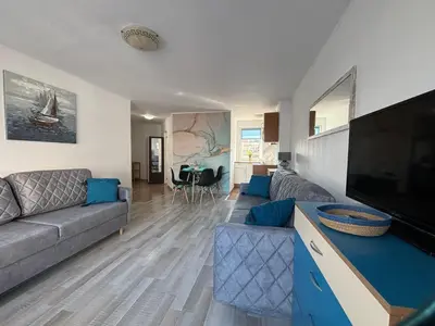 a living room with a couch and a flat screen tv at BW - Aquamarin C6 in Sunny Beach