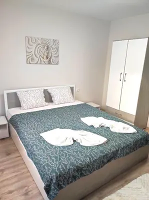 a bedroom with a bed with two towels on it at VN Home 1 in Pomorie