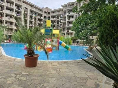 a large swimming pool with a playground in a building at Cascadas Family Resort apartment pool view in Sunny Beach