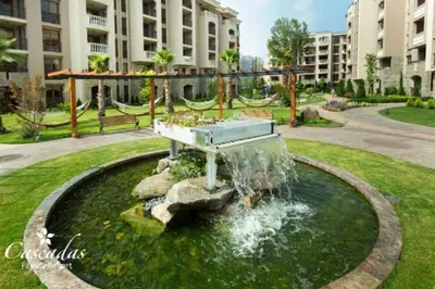 a fountain in the middle of a park at Cascadas Family Resort apartment pool view in Sunny Beach