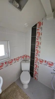 a bathroom with a toilet and a sink at Къща за гости АВЛИГА in Varna City
