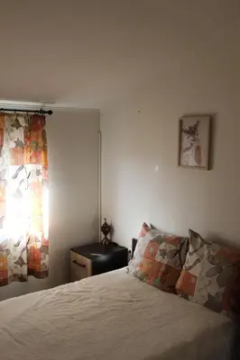 a bedroom with a bed and a window at Къща за гости АВЛИГА in Varna City