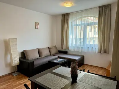 a living room with a couch and a table at Прекрасно място за нощувки в Слънчев бряг in Sunny Beach
