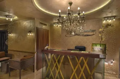 a bar in a restaurant with a chandelier at Прекрасно място за нощувки в Слънчев бряг in Sunny Beach