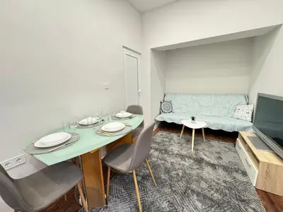 a living room with a table and a couch at Apartment Compass- Super Center Burgas in Burgas City