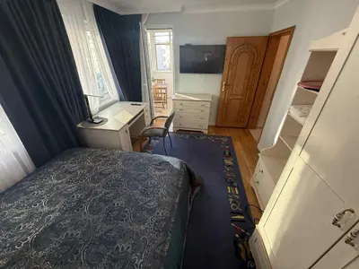 a small bedroom with a bed and a desk at Victoria- две спални делукс до Морската градина и центъра in Burgas City