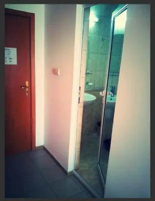 a bathroom with a glass shower with a sink at Concordia Plaza 2 in Primorsko