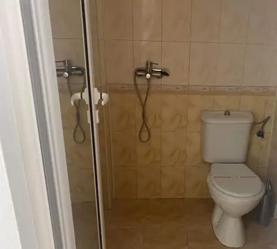 a bathroom with a toilet and a shower at Concordia Plaza 2 in Primorsko