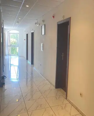 an empty hallway with a door and a tile floor at Concordia Plaza 2 in Primorsko