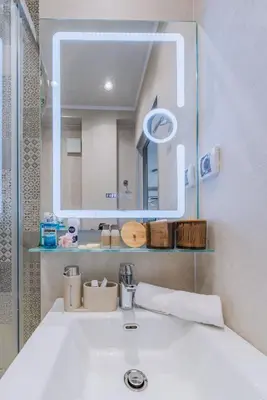 a bathroom with a sink and a mirror at Luxury Seaside Apartment in Varna City