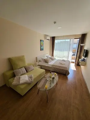 a living room with a couch and a bed at Privet apartament in Premier Fort in Sveti Vlas