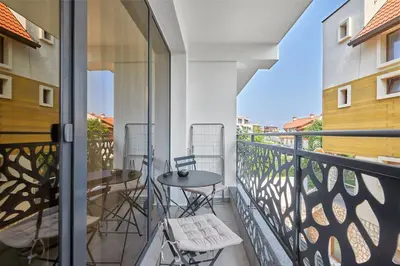 a balcony with a table and chairs on it at Sea Sunrise Apartment Sozopol in Sozopol