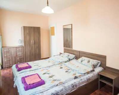 a bedroom with a bed with two pillows on it at LAZUR - Nice Sunny Flat in Burgas City