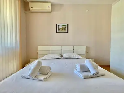 a large white bed with two pillows on it at Prestige Fort Aparthotel - Private apartment - BSR - 1 in Sveti Vlas