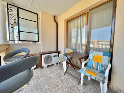 a room with a table and chairs and a window at Prestige Fort Aparthotel - Private apartment - BSR - 1 in Sveti Vlas