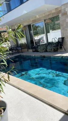 a swimming pool with blue water in a house at Dimargo in Lozenets