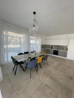 a kitchen with a dining room table and chairs at Dimargo in Lozenets
