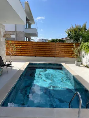 a swimming pool in the backyard of a house at Dimargo in Lozenets