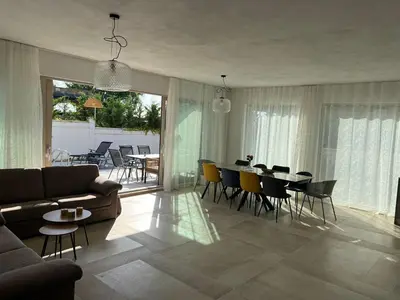 a living room with a couch and a table and chairs at Dimargo in Lozenets