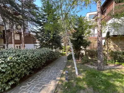 a walkway in front of a building with trees at Aquamarine Studio in Santa Marina in Sozopol
