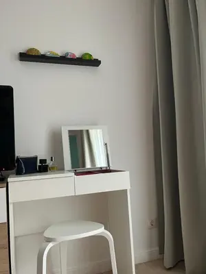 a white desk with a mirror and a stool at Aquamarine Studio in Santa Marina in Sozopol