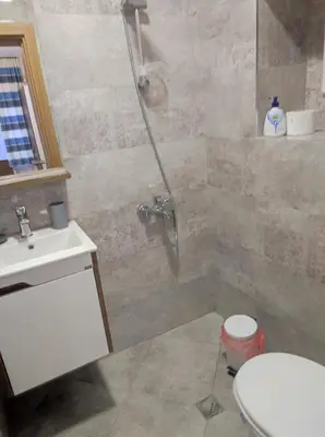 a bathroom with a shower and a toilet and a sink at Студио в центъра на стария Несебър in Nesebar