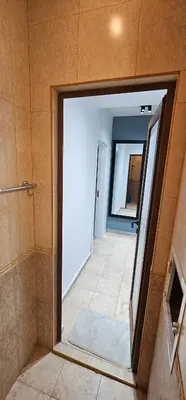 a bathroom with a large mirror in a room at Studio Nikol in Burgas City