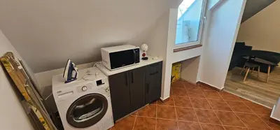 a washing machine with a tv on top of it at Studio Nikol in Burgas City