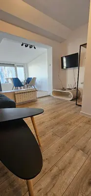 a living room with a table and a television at Studio Nikol in Burgas City