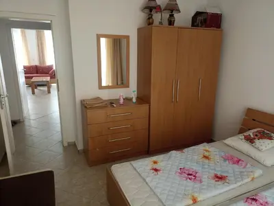 a bedroom with a bed and a dresser with a mirror at SilverSprings Lucie in Sunny Beach